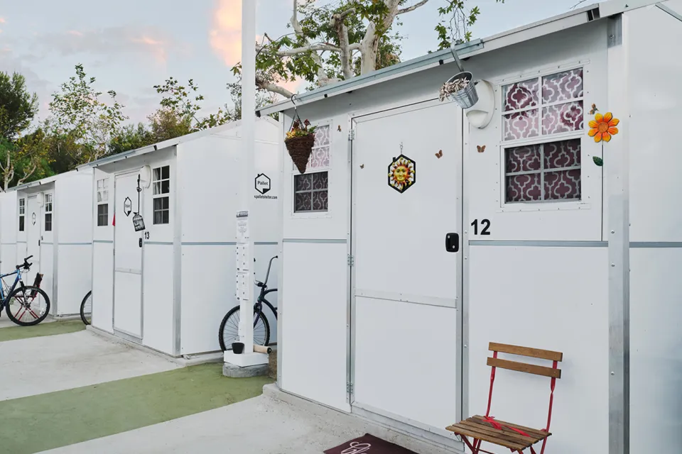 Row of Pallet Shelter tiny home units with bicycles in front